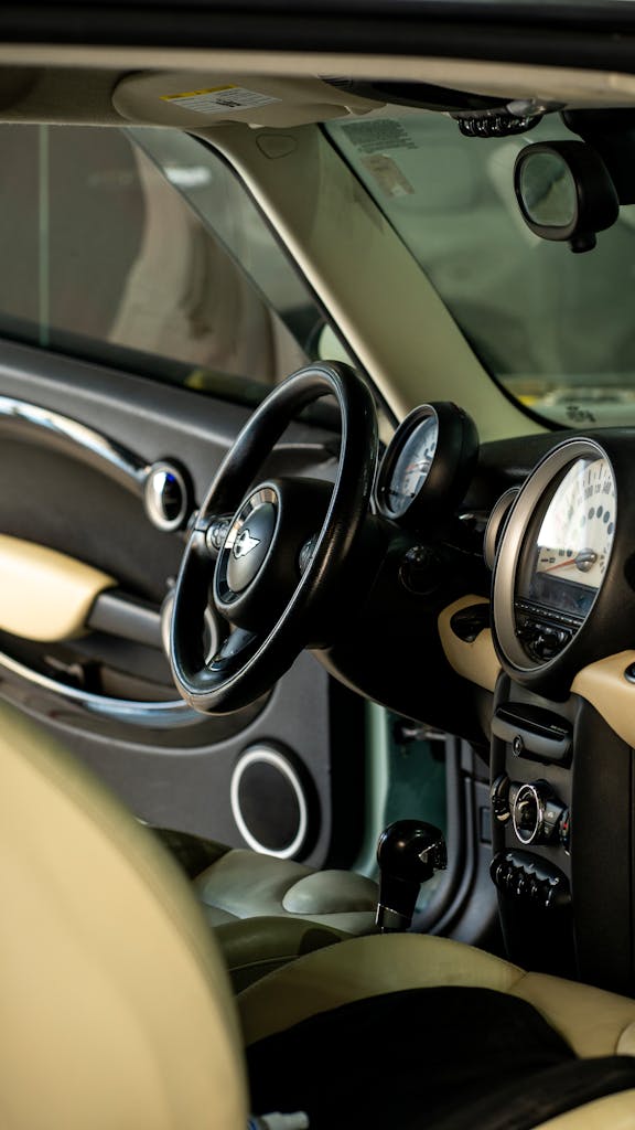 Explore the luxurious interior of a vintage car with a detailed close-up of the dashboard and steering wheel.